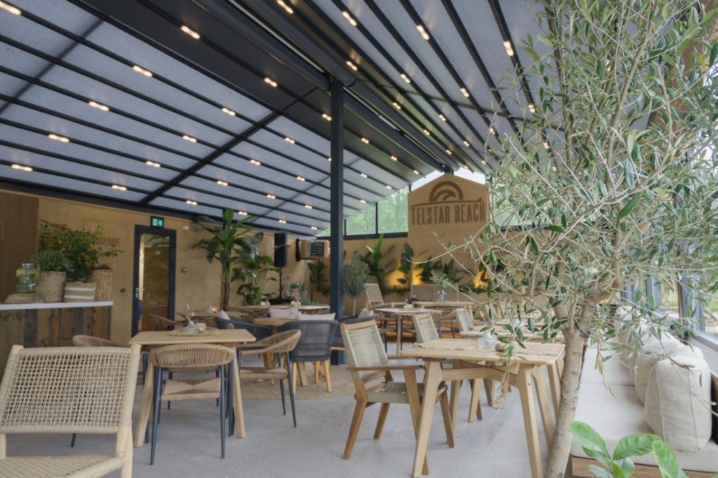 Indoor restaurant terrace with Soltis 96 Proof shading and tropical decor at Telstar Beach