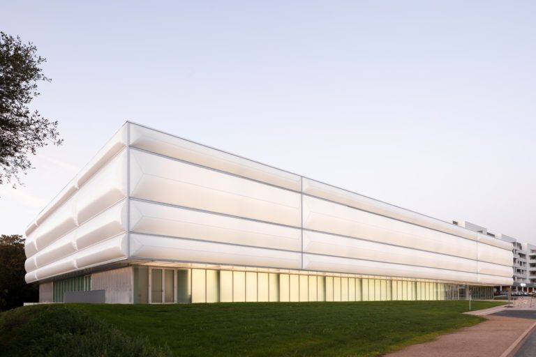 Side view of Hennebont Table Tennis Centre with continuous translucent textile claddin