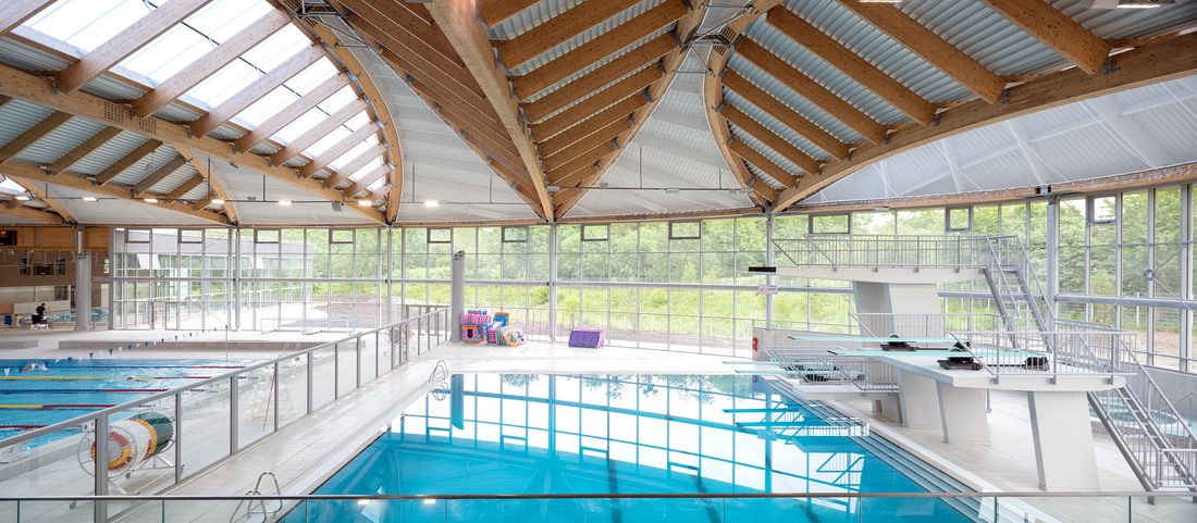 Close-up of textile façade elements and glazed entrance of Taverny Aquatic Center