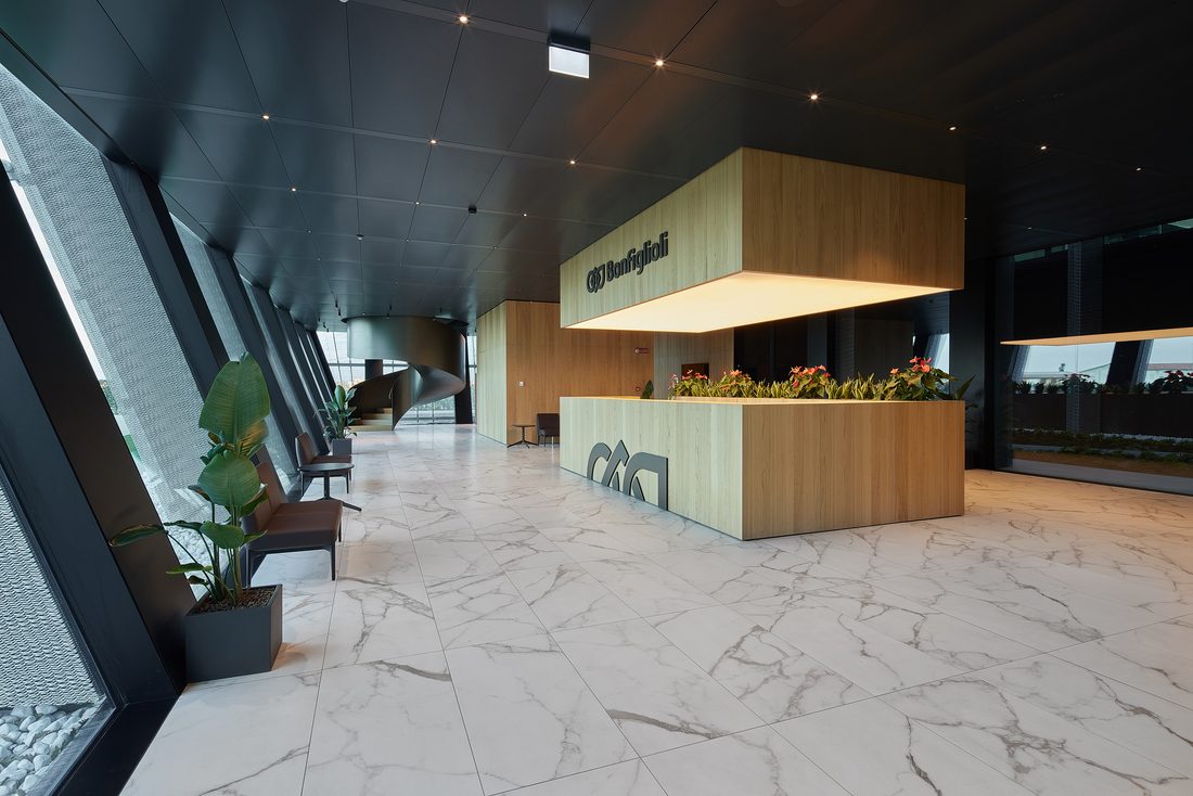 Modern and bright entrance lobby at the Bonfiglioli headquarters with wooden reception desk