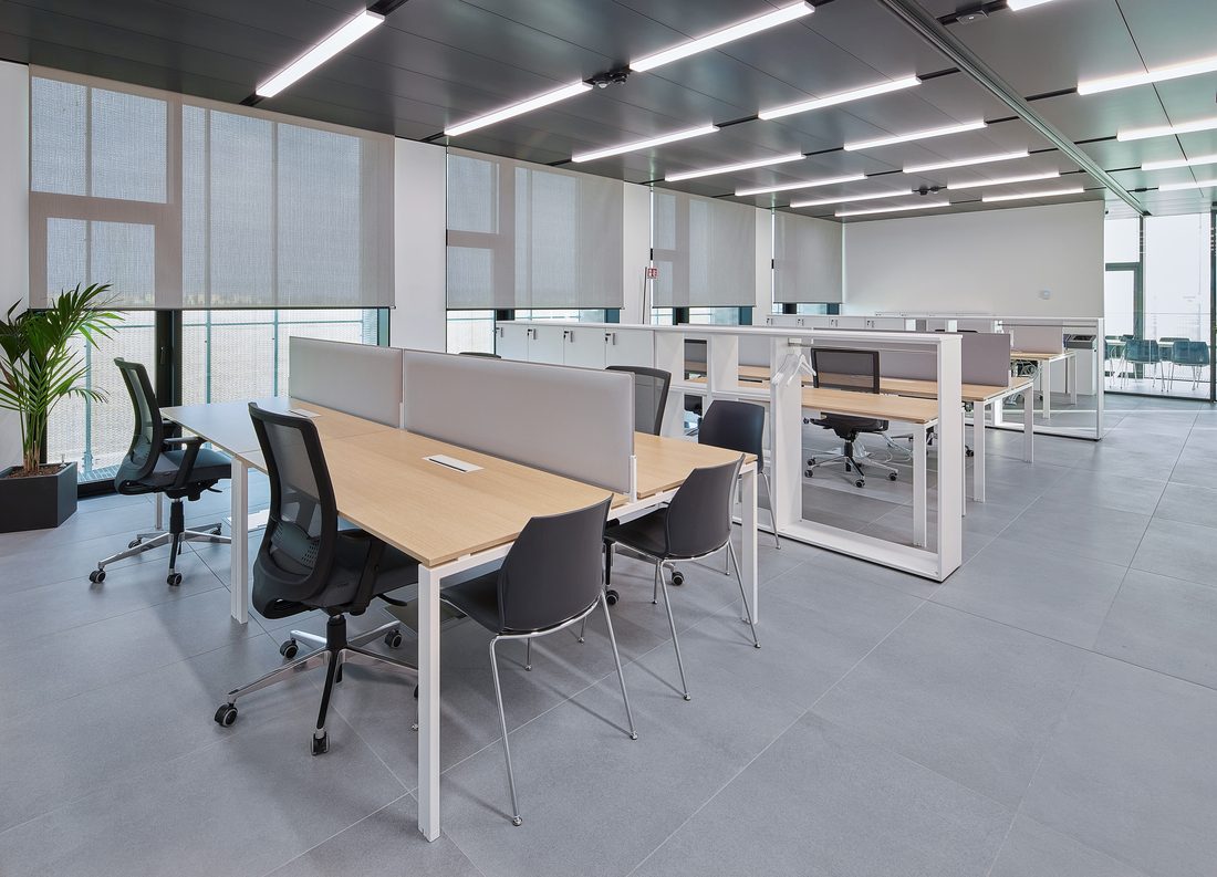 Bonfiglioli open-plan office with workstations and textile solar protection