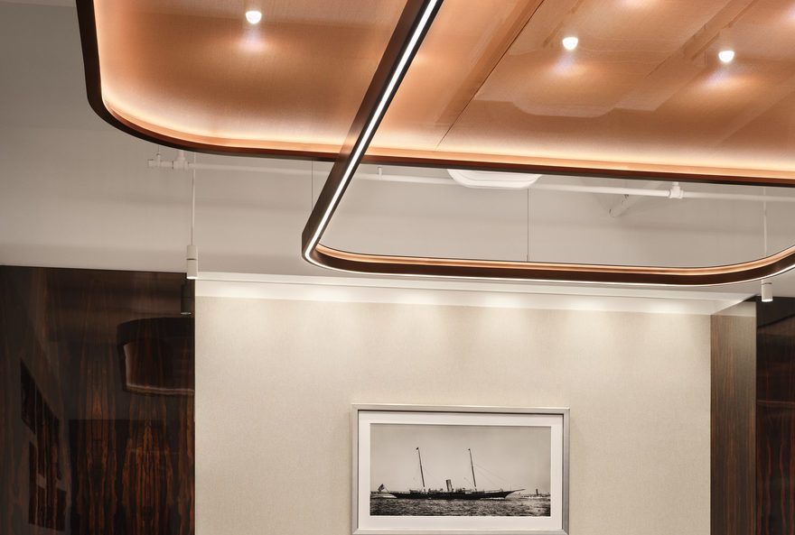 Modern workstation at Corsair NYC with warm-tone ceilings and contemporary furniture