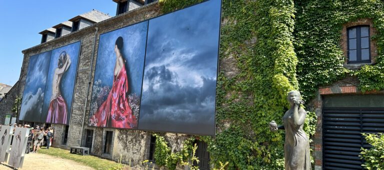 Installation photographique monumentale en façade au Festival Photo de La Gacilly, impressions grand format sur bâche Serge Ferrari