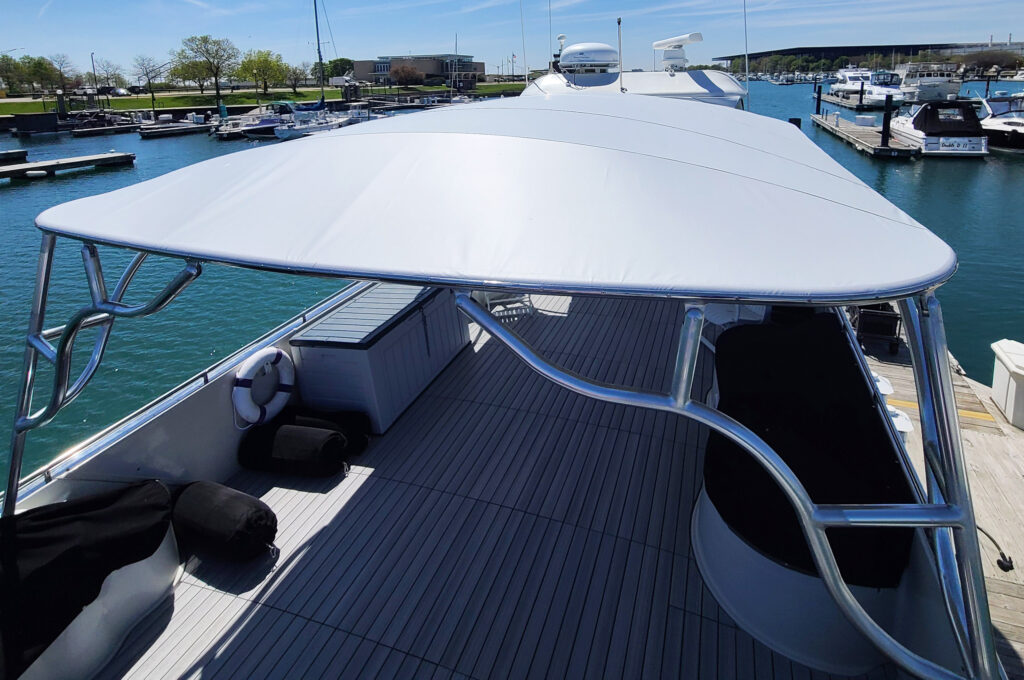 Top view of the Stamoid Top permanent canopy stretched across a tubular frame on a Bluewater Coastal Cruiser 68.