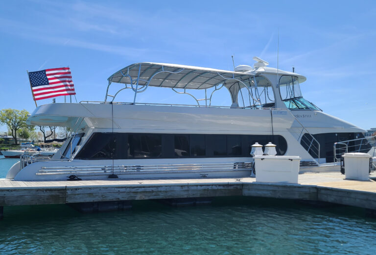 Bluewater Coastal Cruiser 68 at dock with Stamoid Top permanent upper-deck canopy installed, showing the yacht and marina setting.