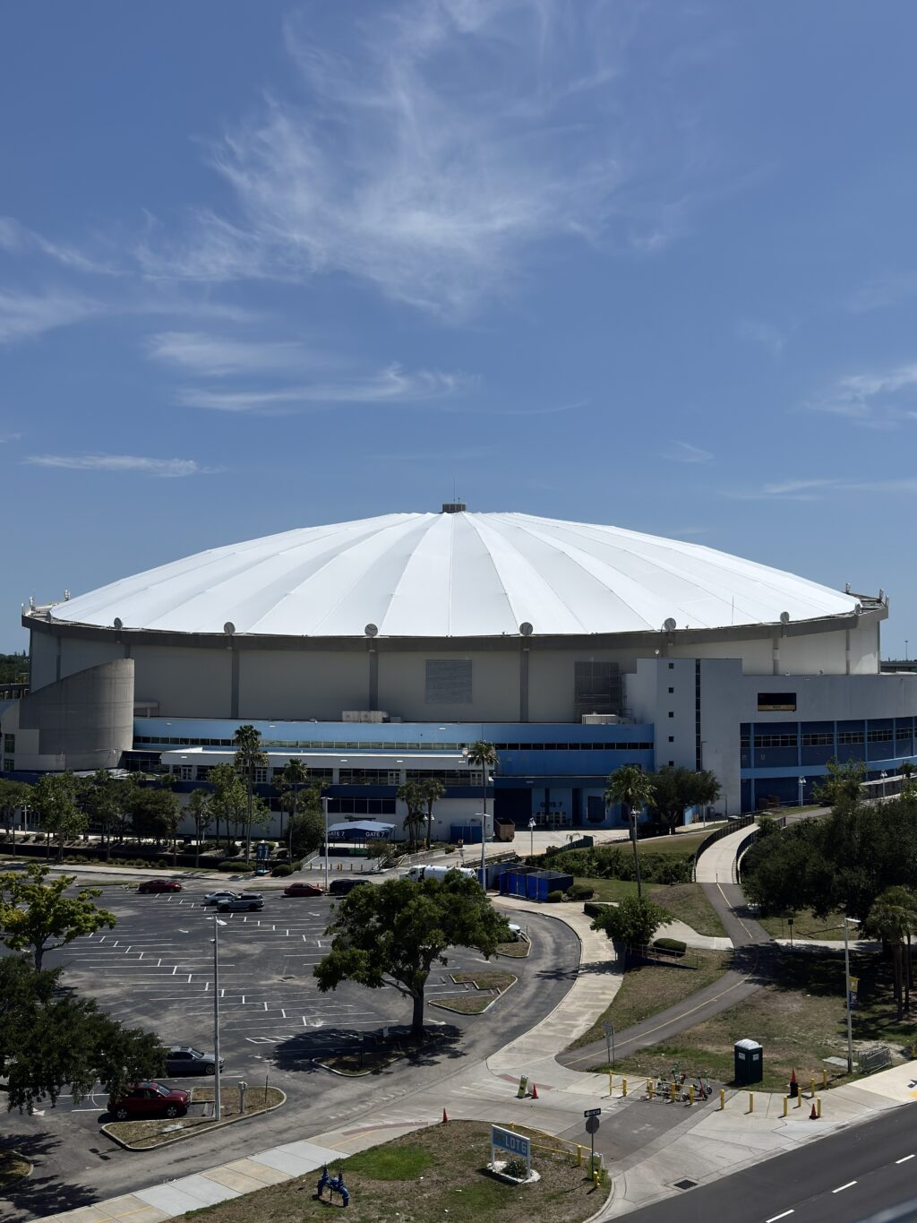 Exterior view of Tropicana Field showing the large white domed tensile roof rising above the stadium complex.