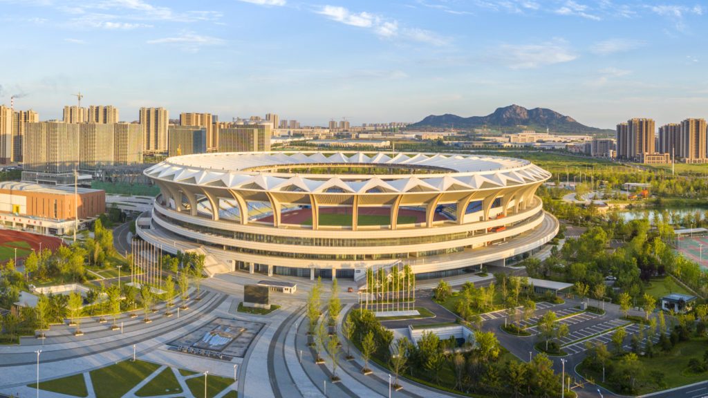 Exterior view of Kuishan Stadium with PTFE canopy integrated into the urban landscape