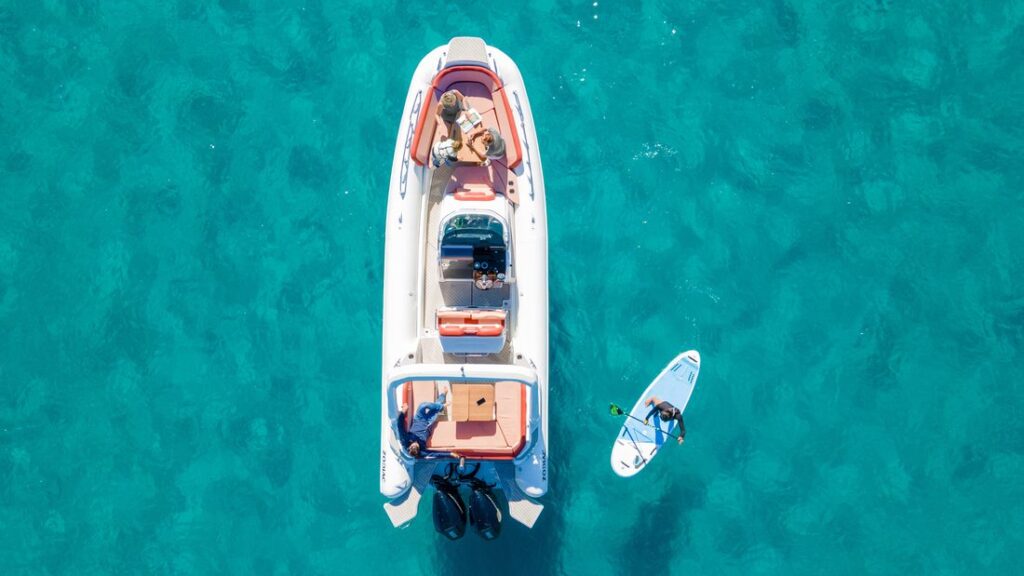 Vue aérienne d’un bateau pneumatique naviguant en mer, mettant en évidence les flotteurs réalisés en membrane composite haute résistance.