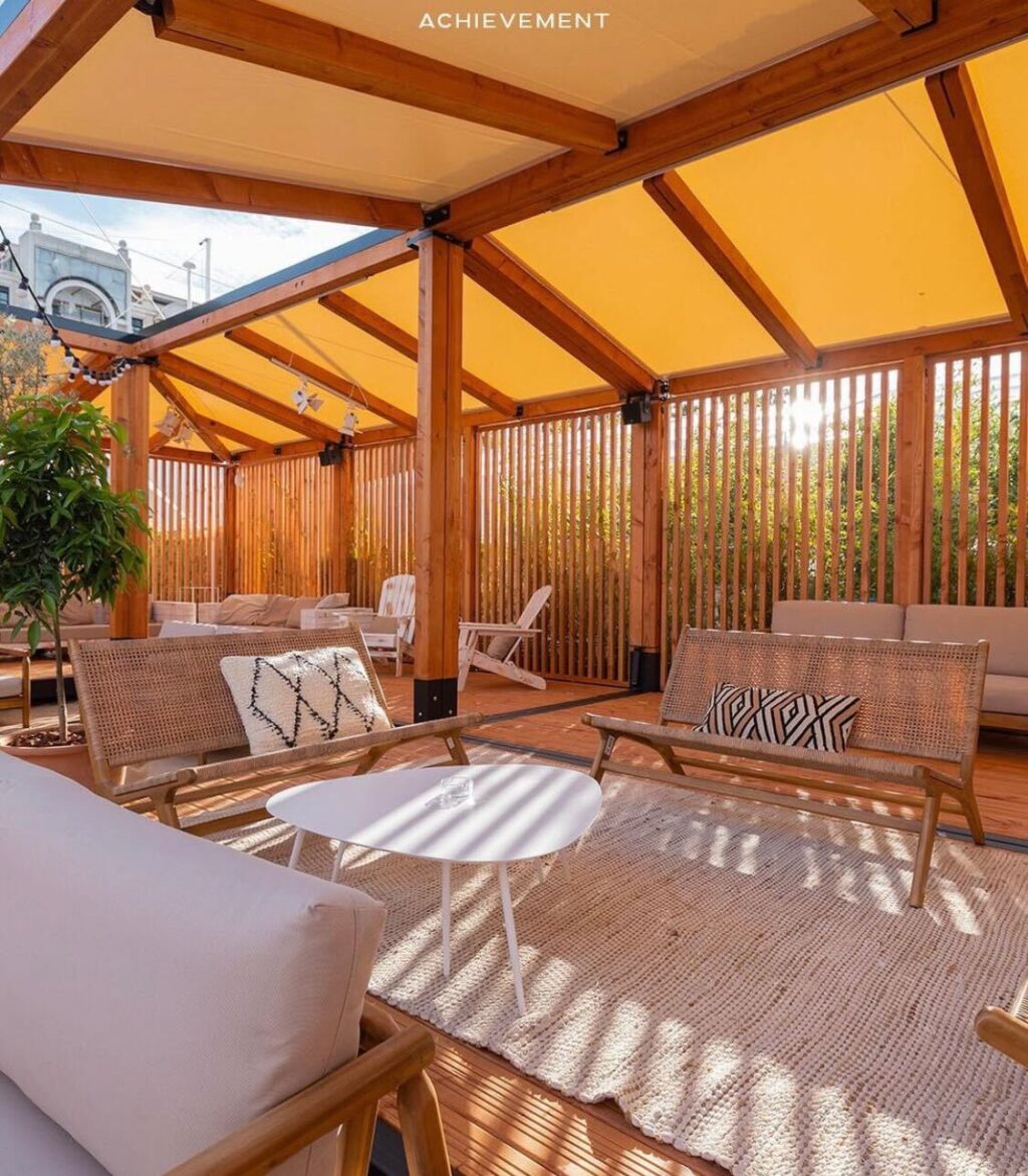 Modular woodbox accommodation with tensile membrane roofing for sporting events